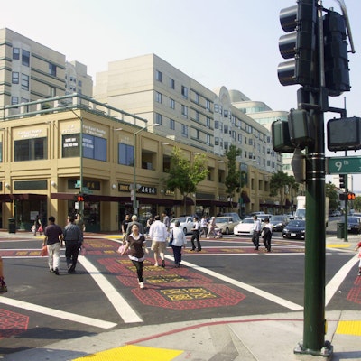 An example of placemaking, many people use all direction crosswalks decorated with colorful patterns specific to Chinatown, Oakland.