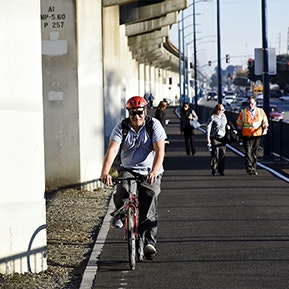 People biking and walking on East Bay Greenway.