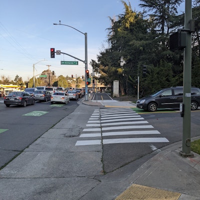 Existing marked crosswalk at an intersection on Macarthur Blvd