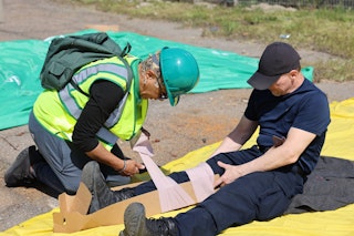 A CERT Member practices disaster medical operations - splinting.
