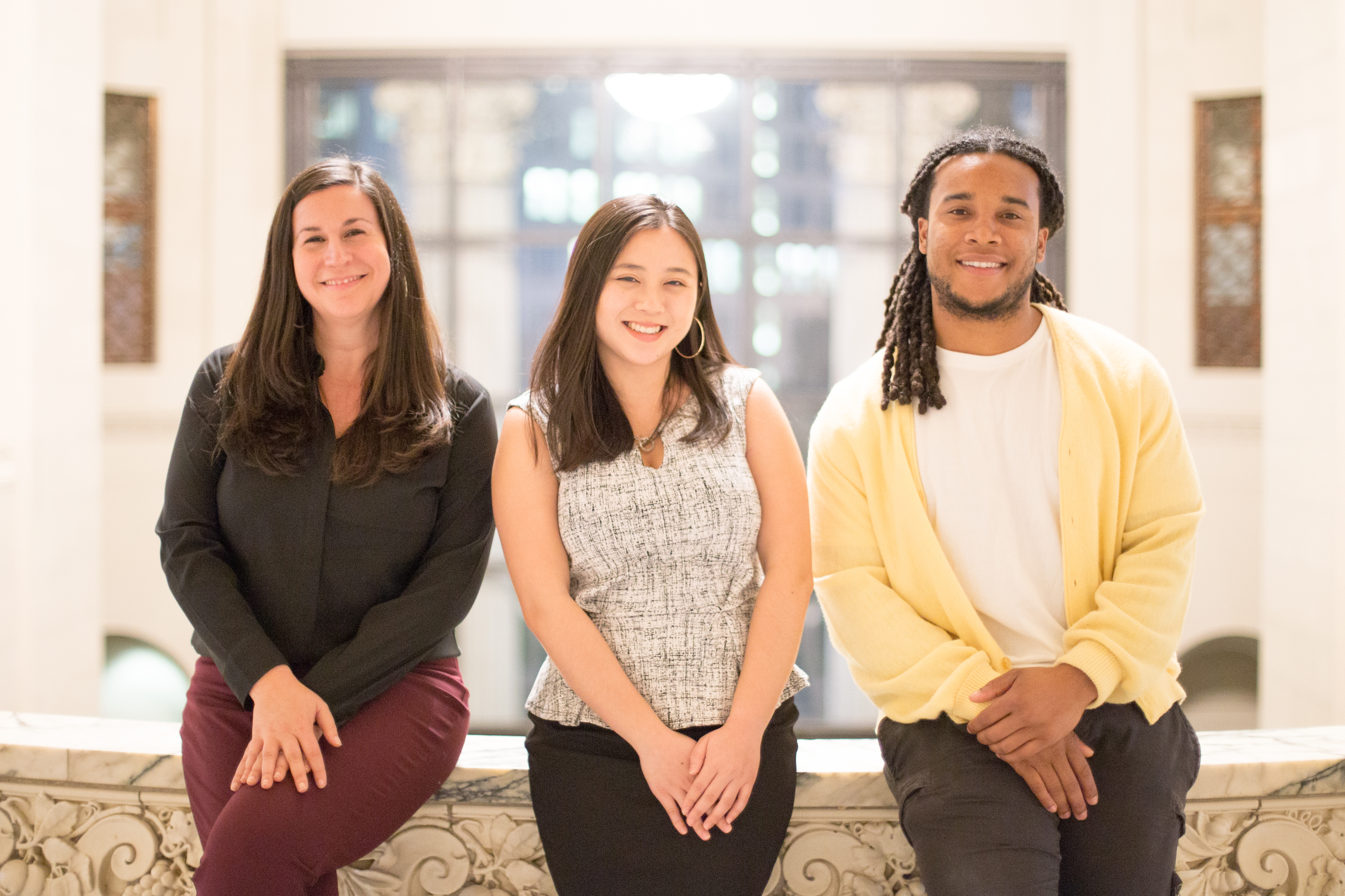 Staff Sara Tiras, Kimberly Woo, and Philip Jones smiling at City Hall