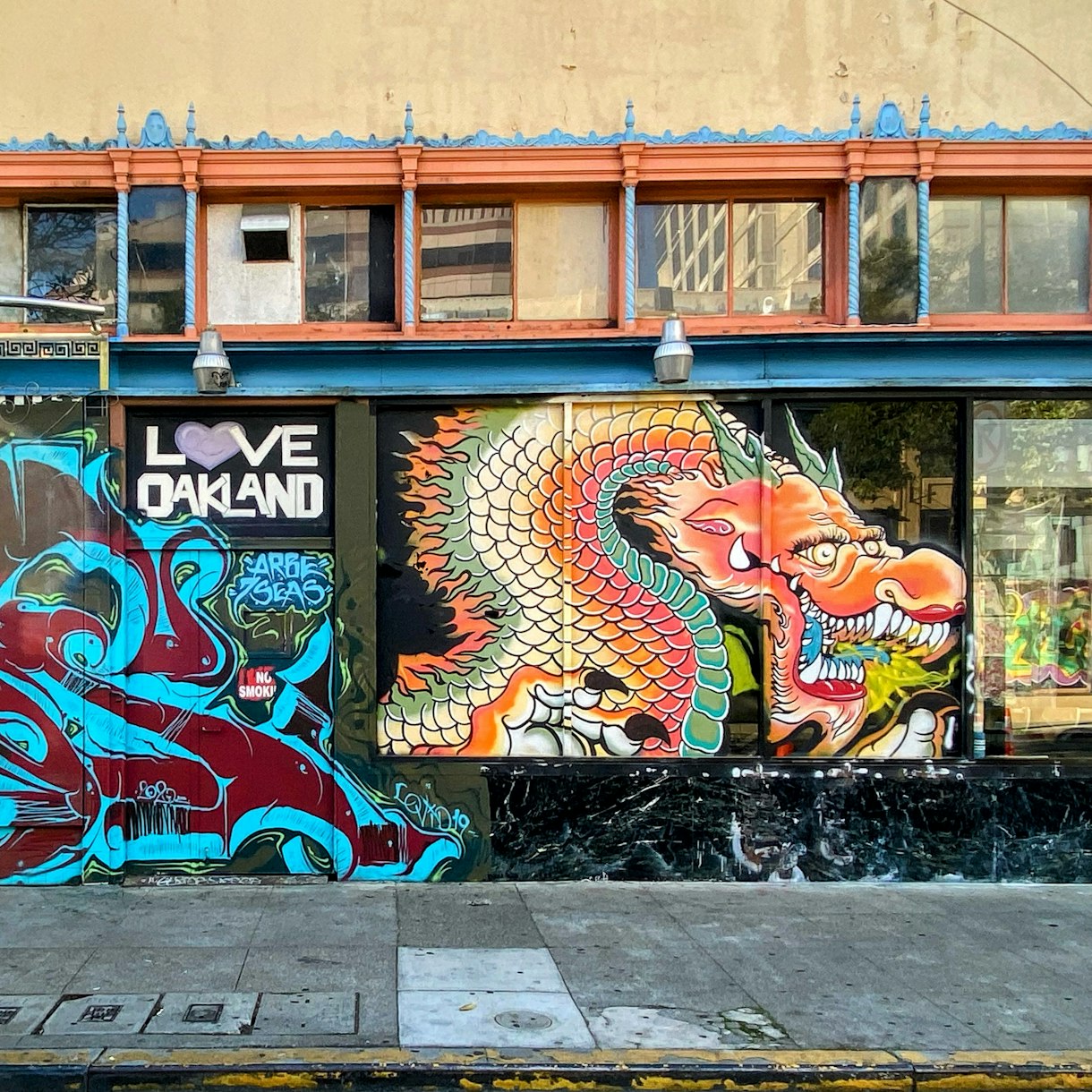 Mural of dragon, with text "love oakland"