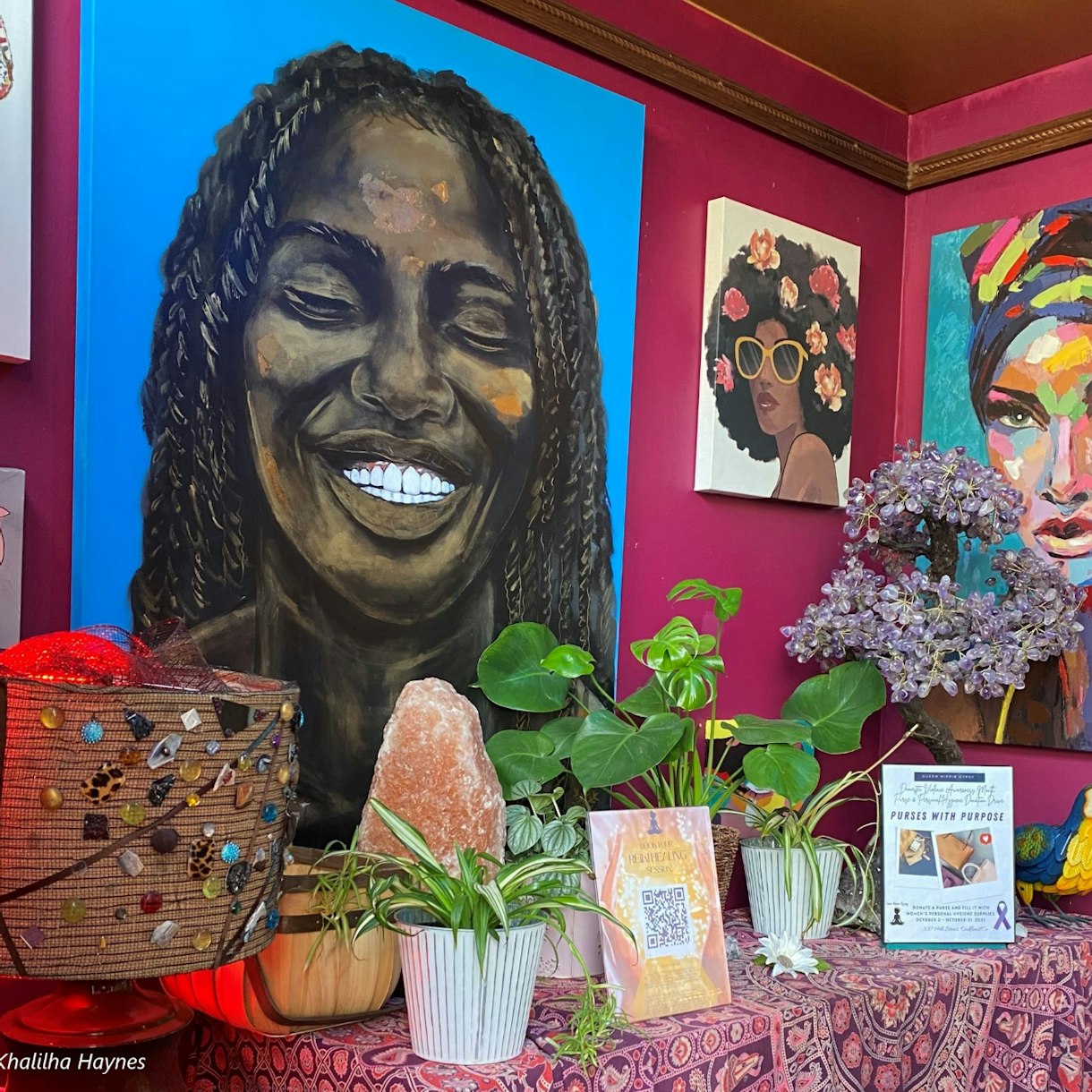 Artwork of differnt black women surroudned by plants and crystals on a table at queen hippie gypsy store in Oakland